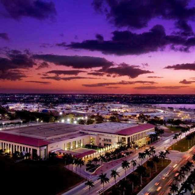 Exterior of entire building and downtown WPB during night aerial view