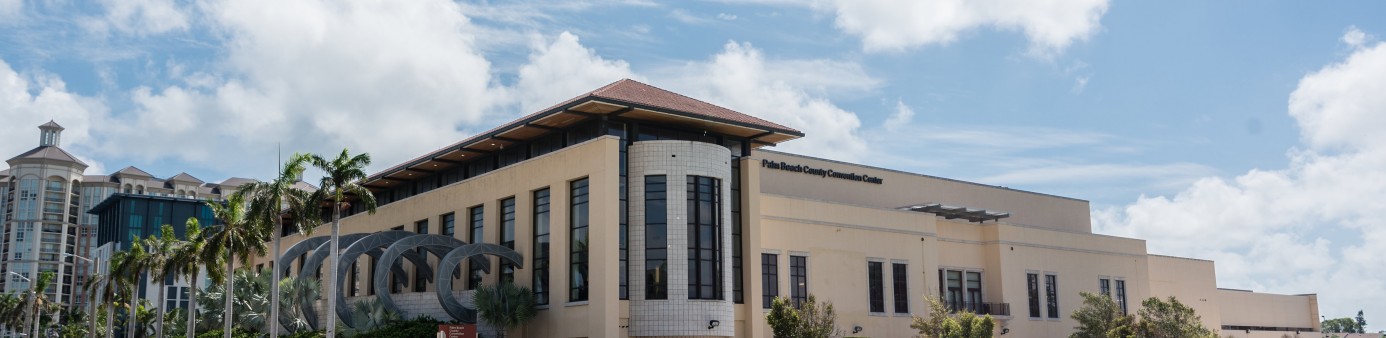 Exterior west side of convention center building with large window overlooking Okceechobee Blvd.