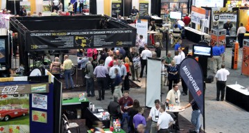 Aerial photo of exhibit set-up with booths and attendees