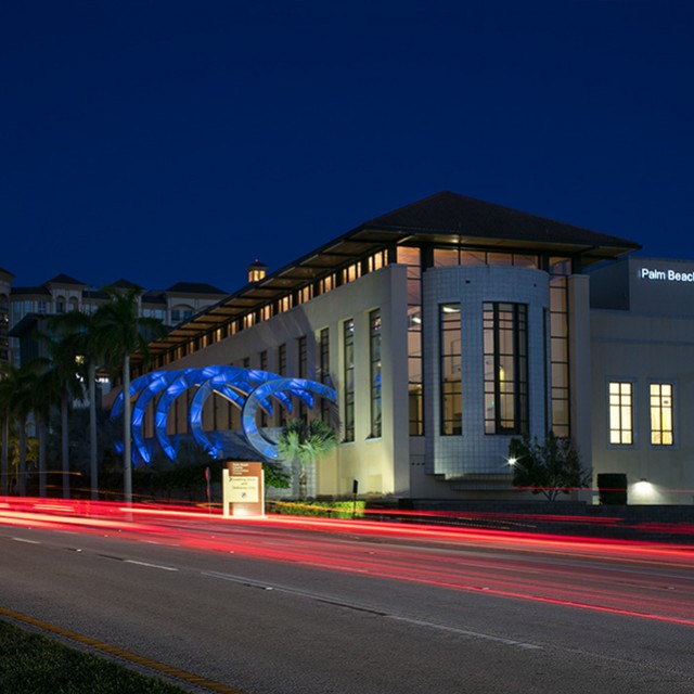 Northside of building at night with large wave lights in blue